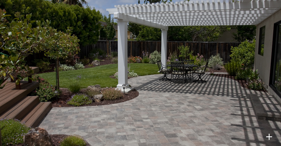 Completed landscape including pavers, Trex deck, Arbor, Sod Lawn and Plants